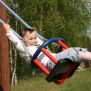 Kid swinging on Wooden Baby Swing
