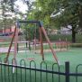 Wooden swing with safetyseat on playground 